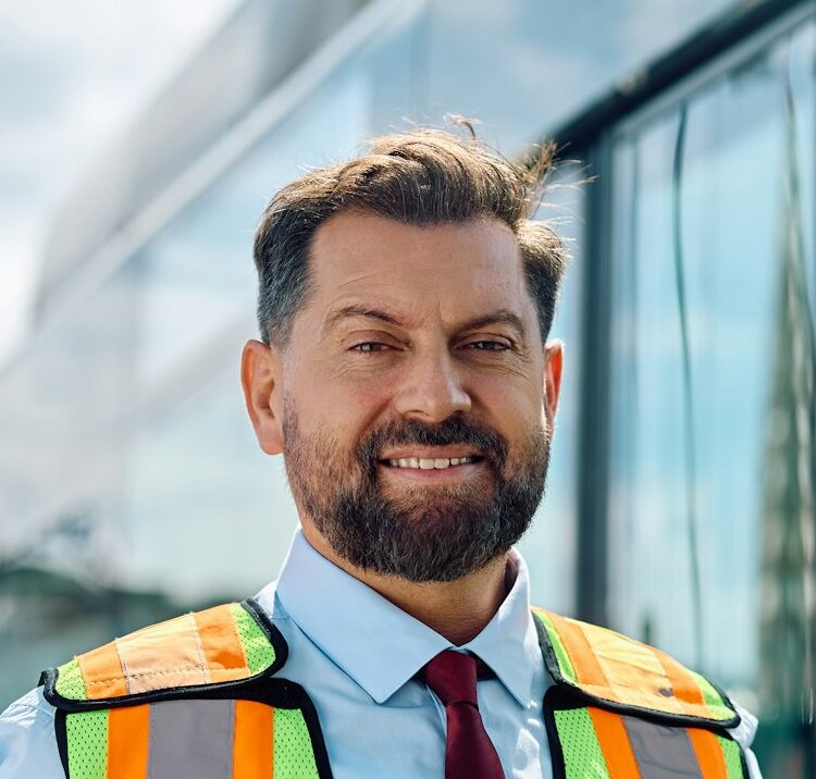 Happy mid adult bus driver looking at camera.